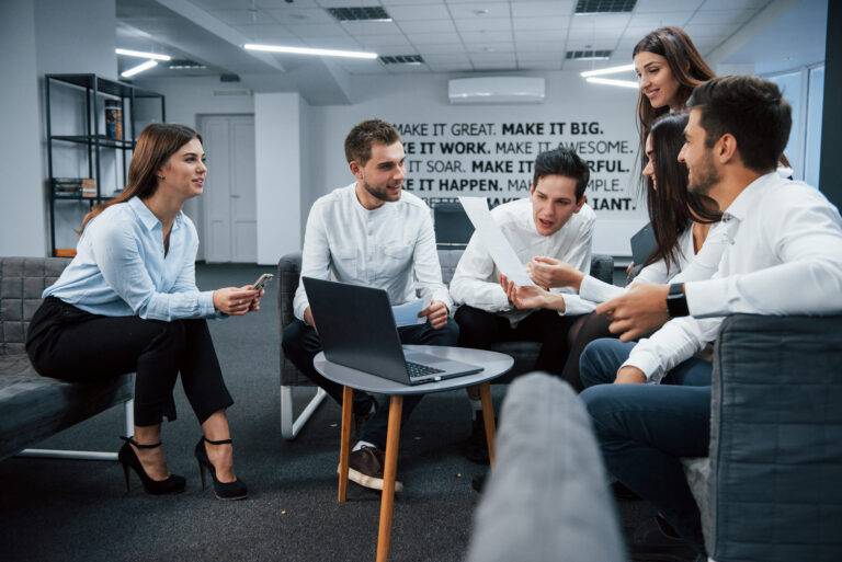 Creative team reviewing visual campaign content on a laptop
